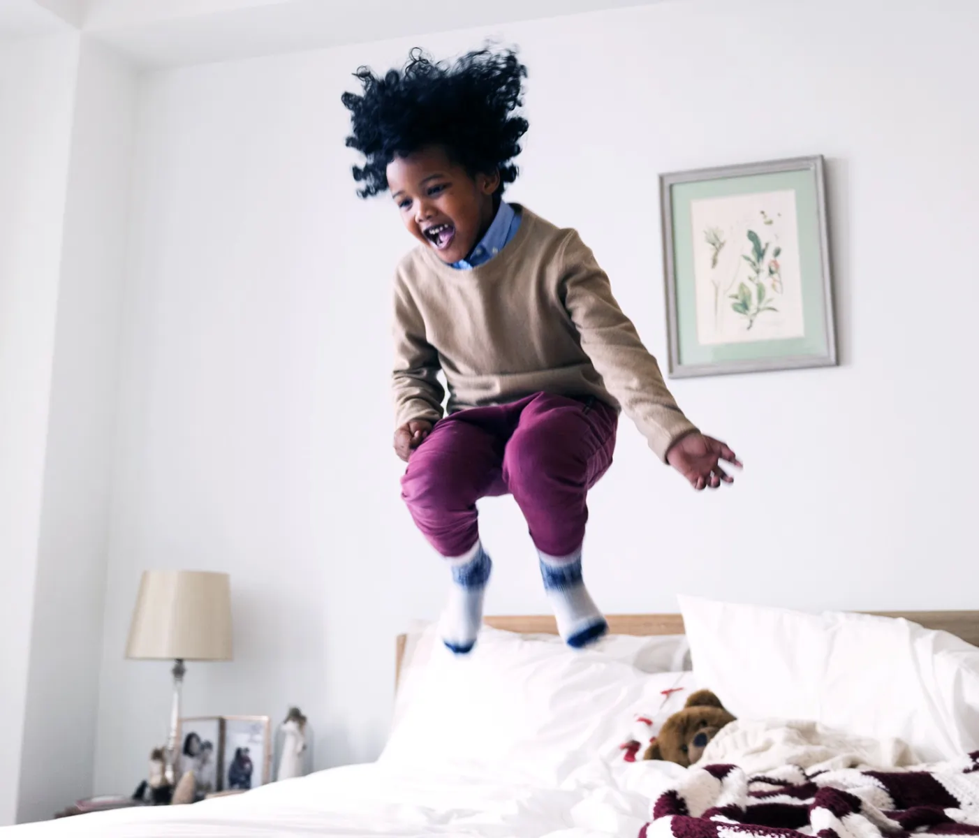 Kid jumping on bed
