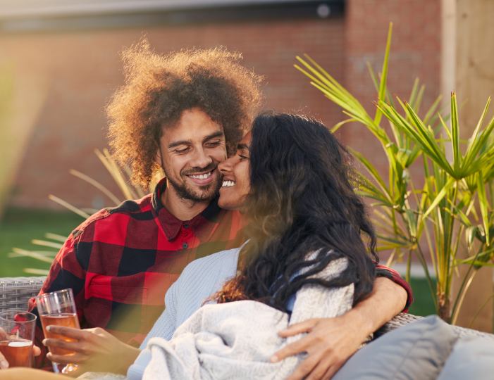 Couple on outdoor furniture
